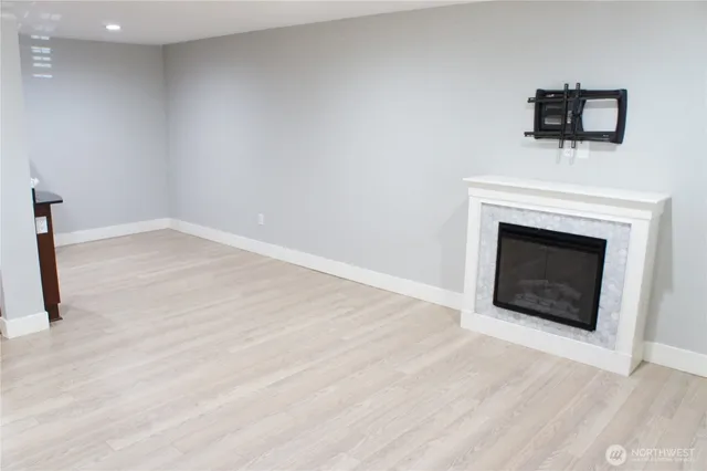 a view of empty room with a fireplace