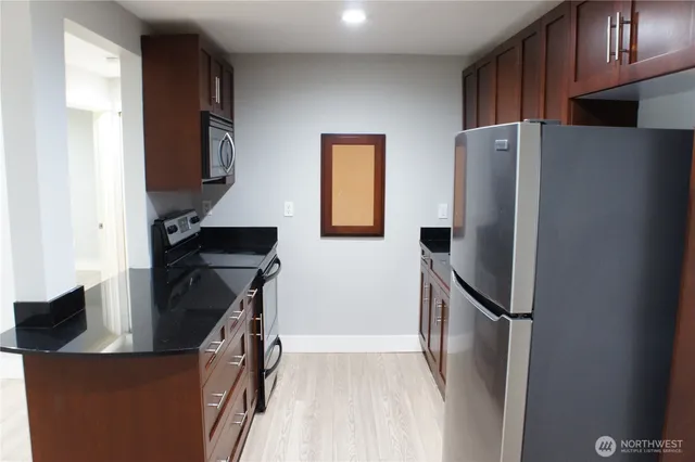 a kitchen with stainless steel appliances a refrigerator and a stove