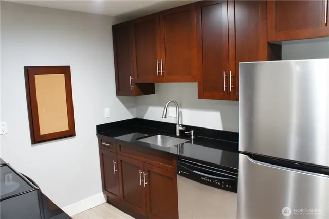 a kitchen with a sink and a refrigerator
