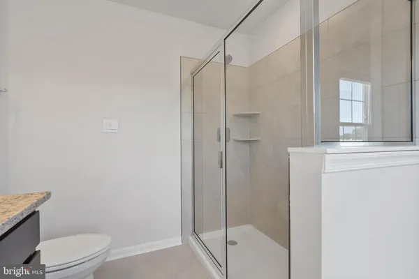 a bathroom with a shower a toilet and a sink