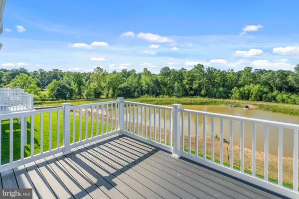 a view of balcony with wooden floor and fence