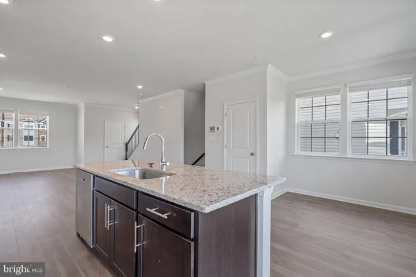 a view of a sink wooden floor and a cabinet in a room