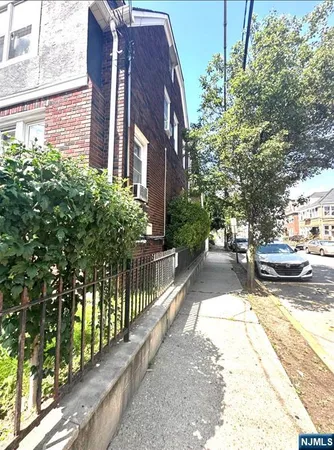 a view of a street with cars on both side of road
