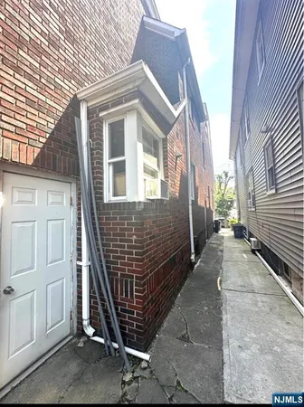 a view of a house with brick walls