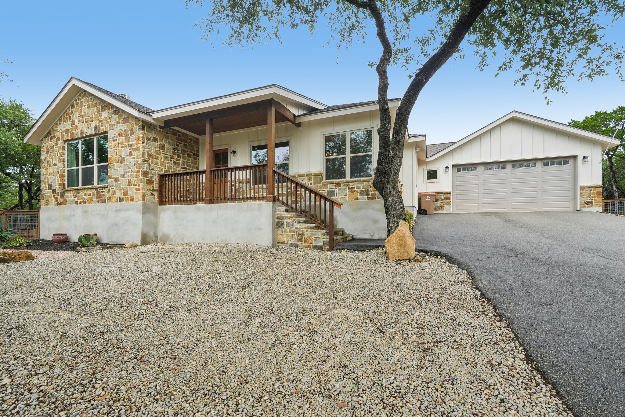 A striking blend of stone and board-and-batten siding graces this home's exterior, offering inviting curb appeal.