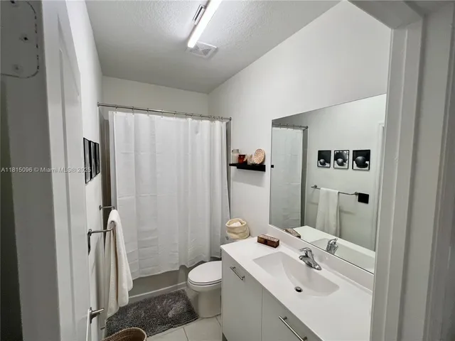 a bedroom with a bed and a mirror