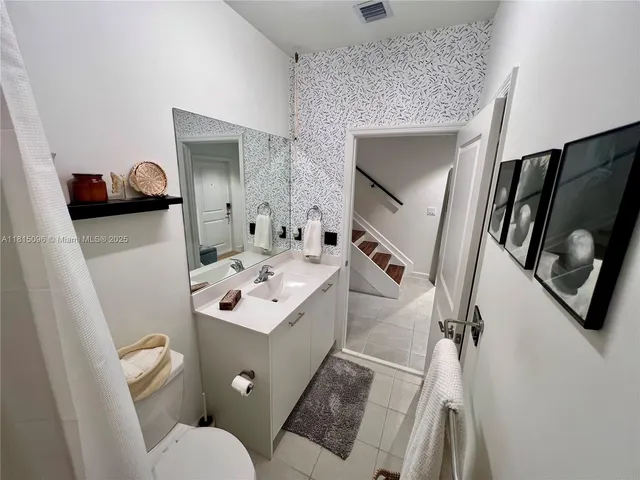 a view of walk in closet with clothes