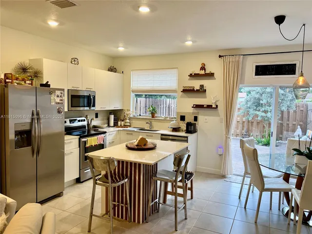 a kitchen with a sink a stove and cabinets
