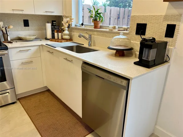 a dining room with furniture and a floor to ceiling window