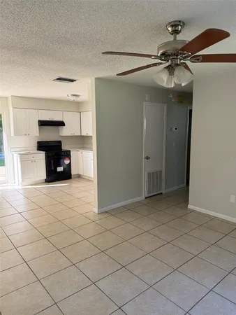 a view of a livingroom and a chandelier fan