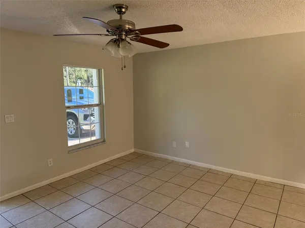 a view of an empty room and a window