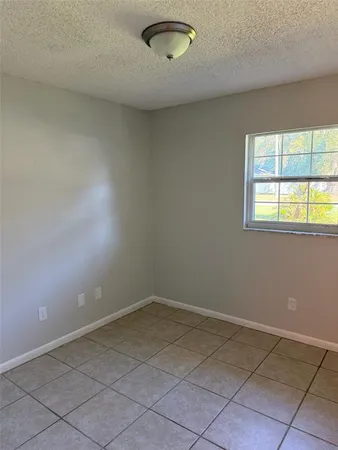 a bathroom with mirror sink and window