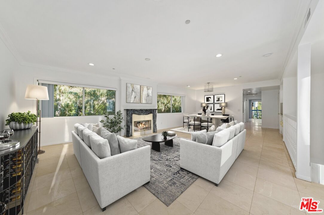 11606 Chenault Street, Unit 403 Los Angeles, CA 90049 - Photo 1 of 21 a living room with furniture and a large window