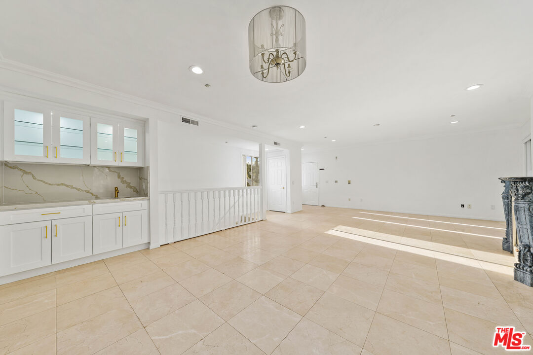 11606 Chenault Street, Unit 403 Los Angeles, CA 90049 - Photo 3 of 21 a view of an empty room and window