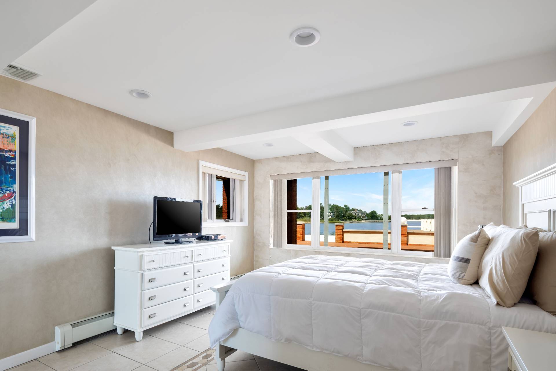 69 B Little Pine Lane East Quogue, NY 11942 - Photo 12 of 34 a bedroom with furniture and flat screen tv