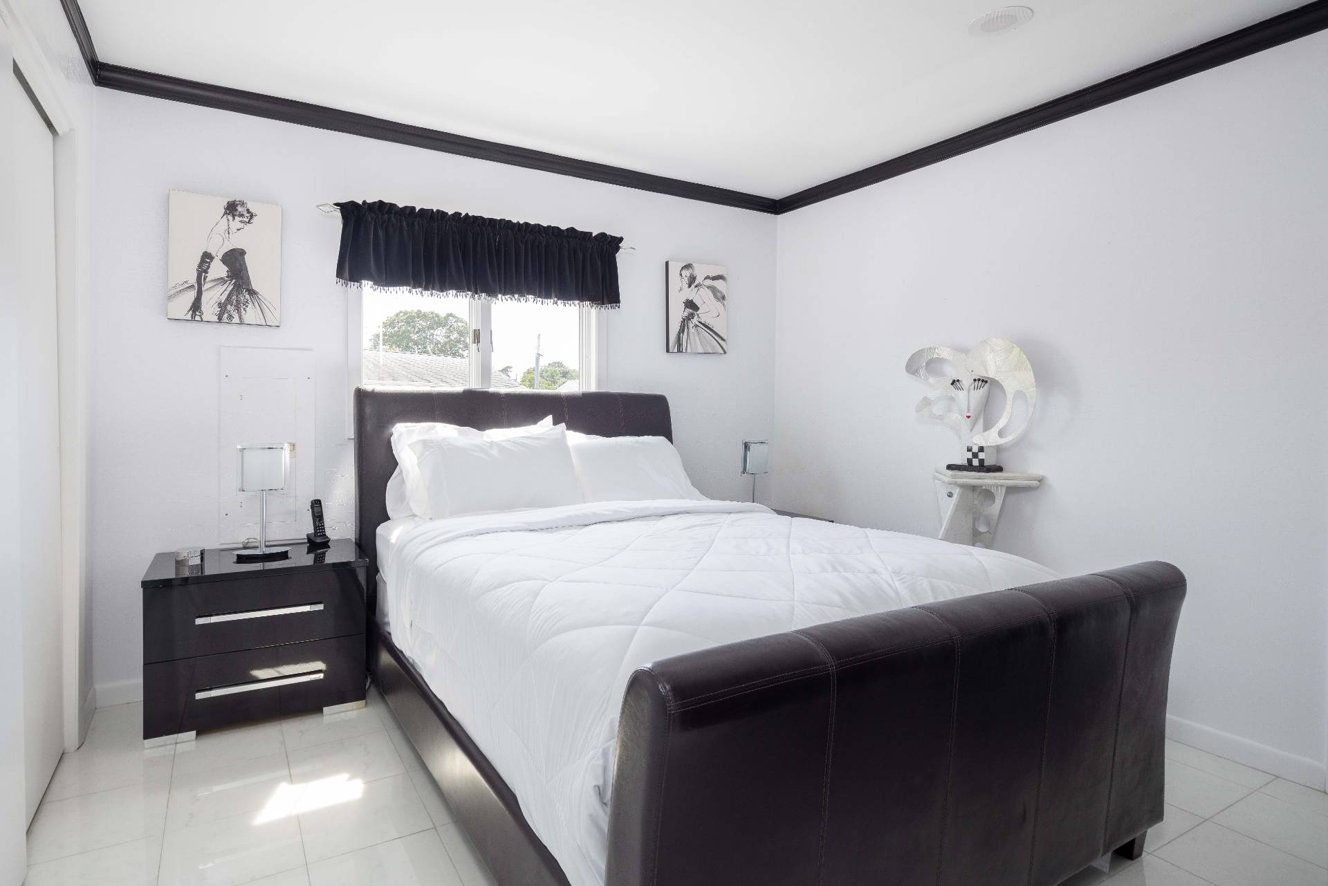 69 B Little Pine Lane East Quogue, NY 11942 - Photo 13 of 34 a bedroom with a bed and a tv on the dresser