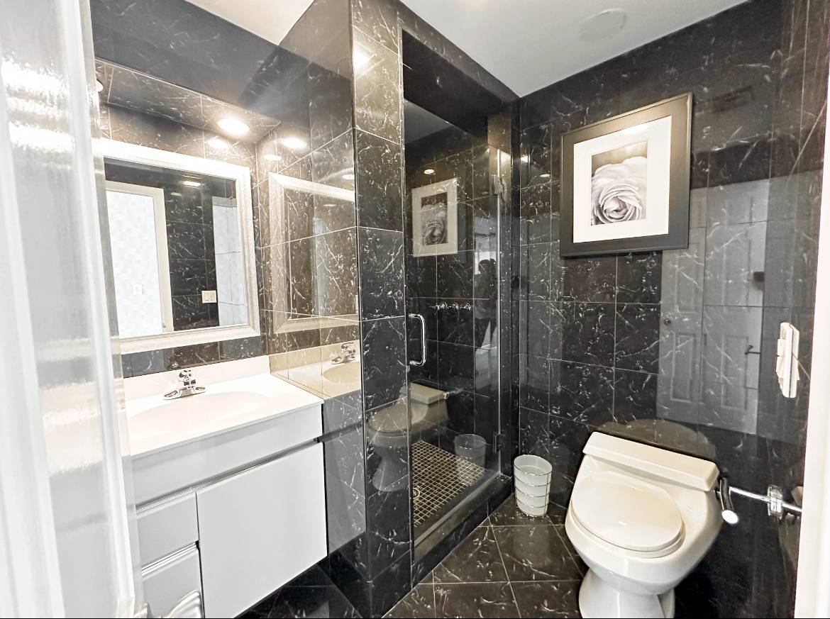 69 B Little Pine Lane East Quogue, NY 11942 - Photo 19 of 34 a bathroom with a toilet sink and mirror