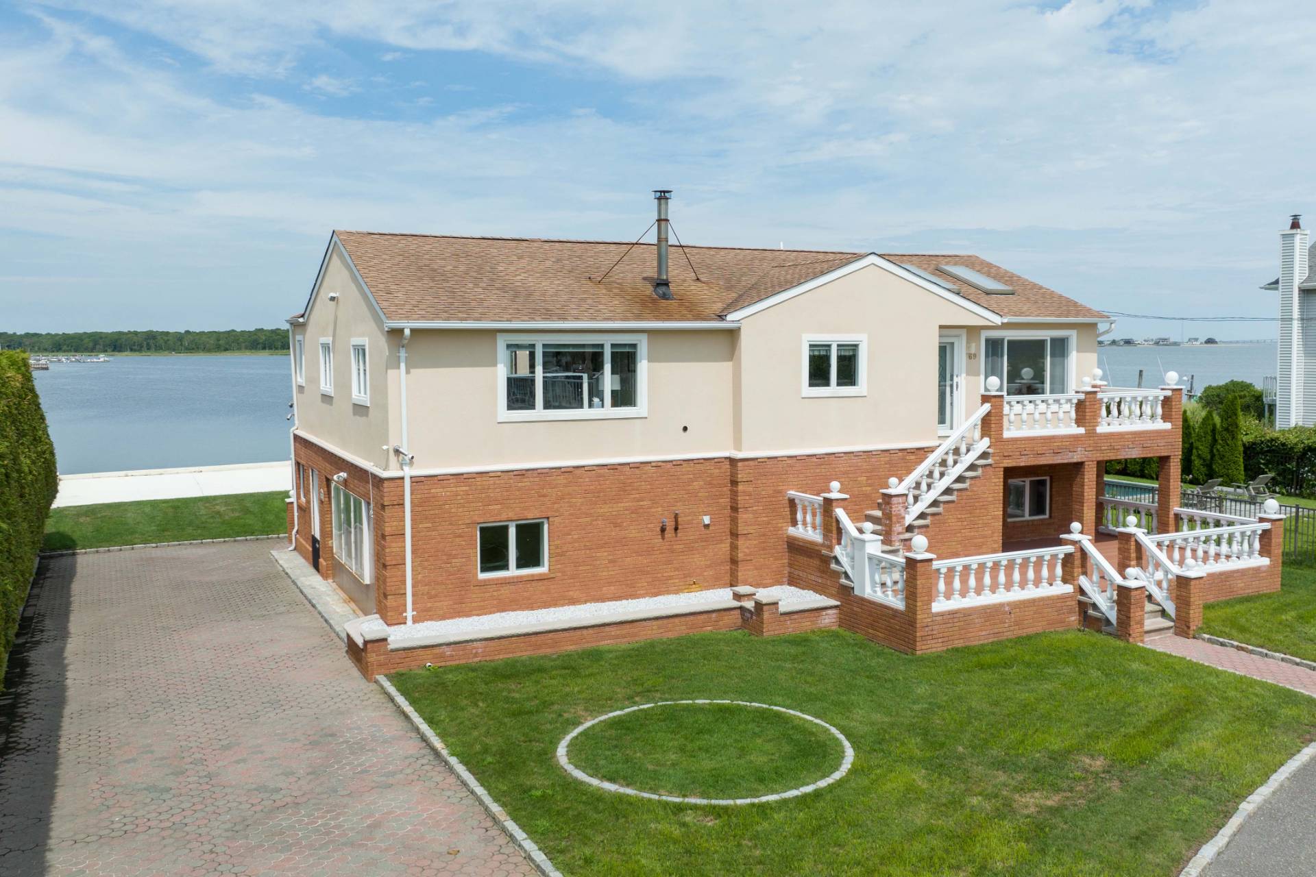 69 B Little Pine Lane East Quogue, NY 11942 - Photo 2 of 34 a front view of a house with garden