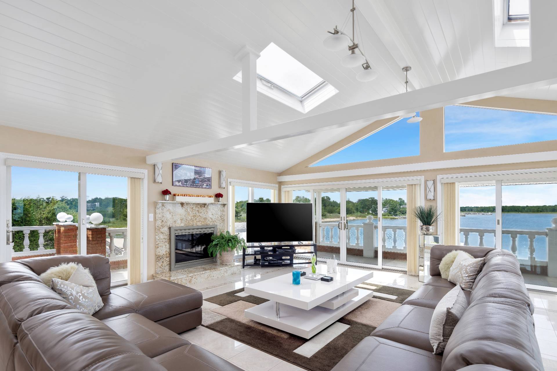 69 B Little Pine Lane East Quogue, NY 11942 - Photo 6 of 34 a living room with furniture a flat screen tv and a large window