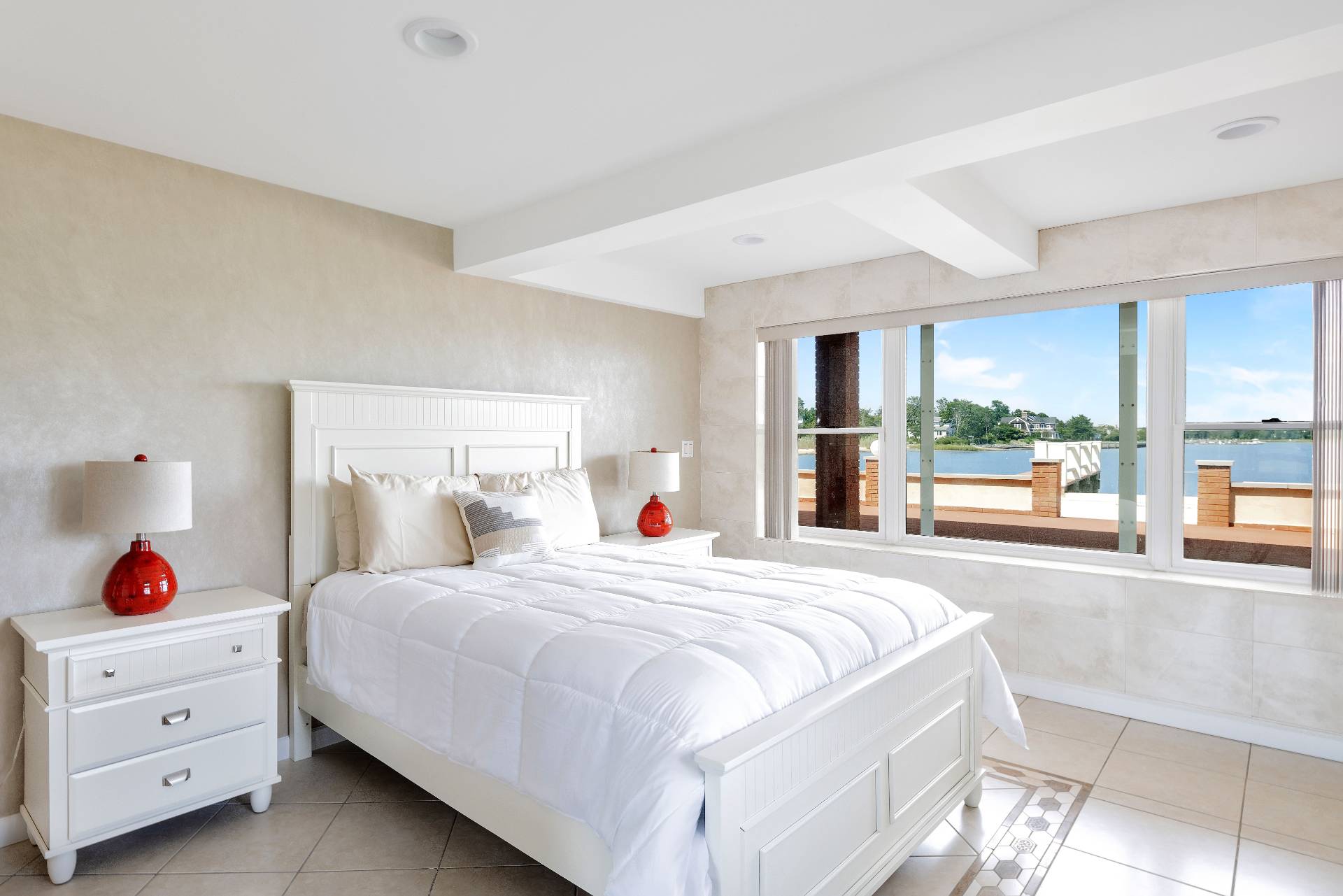 69 B Little Pine Lane East Quogue, NY 11942 - Photo 9 of 34 a bedroom with a bed and a large window