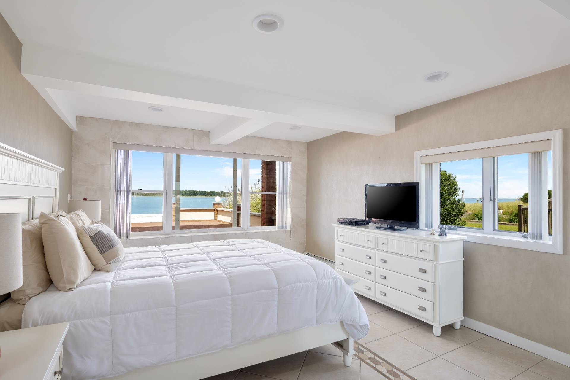 69 B Little Pine Lane East Quogue, NY 11942 - Photo 10 of 34 a bedroom with a bed and flat tv