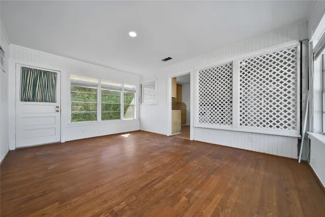 a view of a room with wooden floor