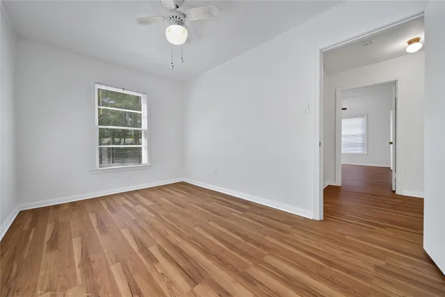 wooden floor in an empty room with a window