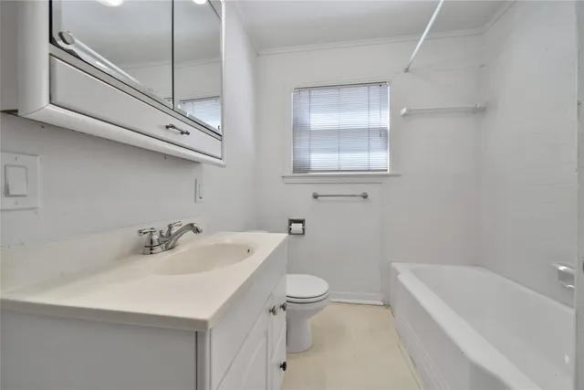 a bathroom with a sink a toilet and bathtub
