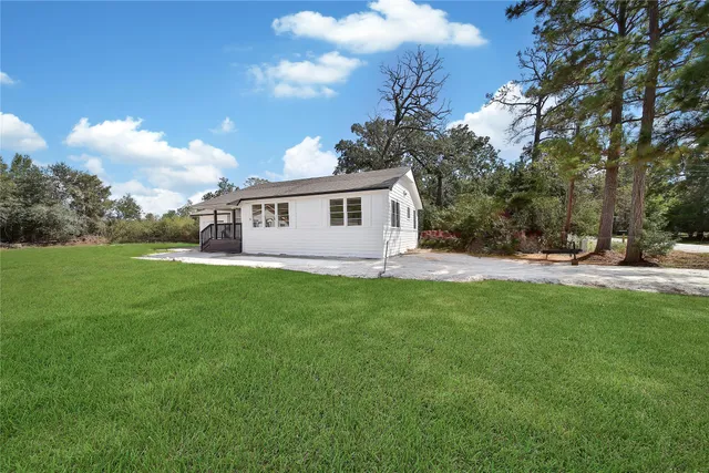 a front view of house with yard and trees