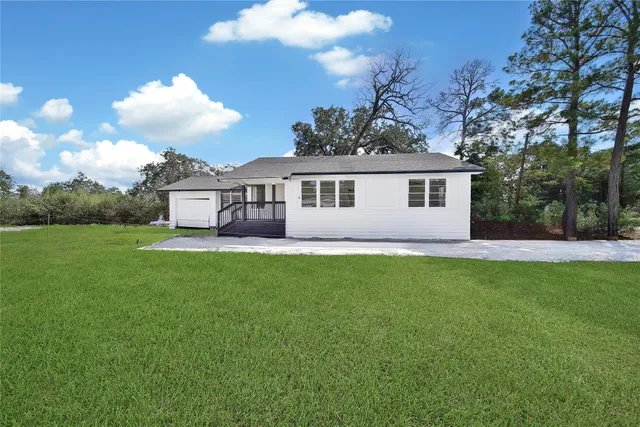a view of a house with a backyard