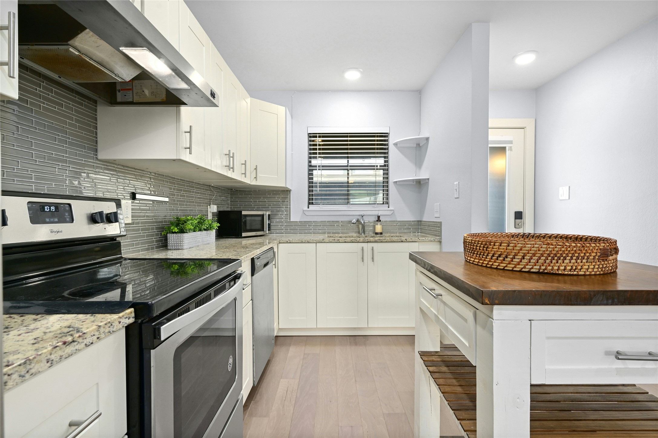 909 Reinli Street, Unit 228 Austin, TX 78751 - Photo 5 of 27 a kitchen with granite countertop stainless steel appliances lots of counter top space a sink a stove and cabinets