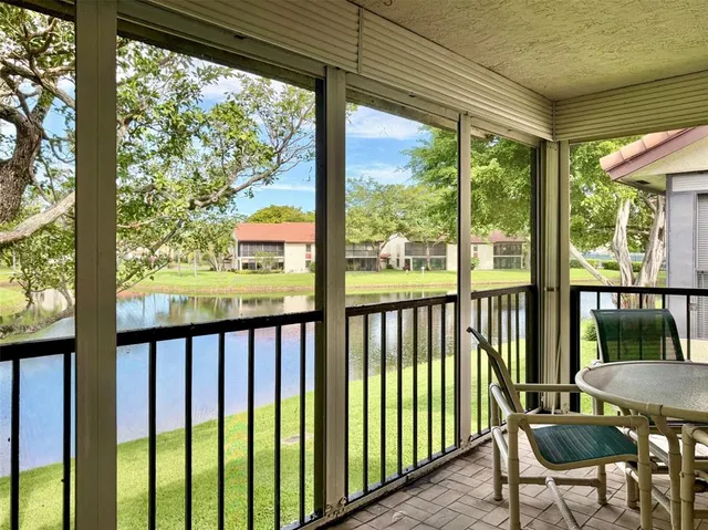 a view of a porch with a table and chairs