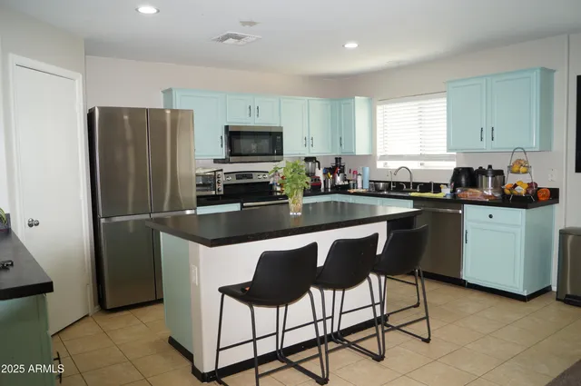 a kitchen with granite countertop a sink stove and cabinets