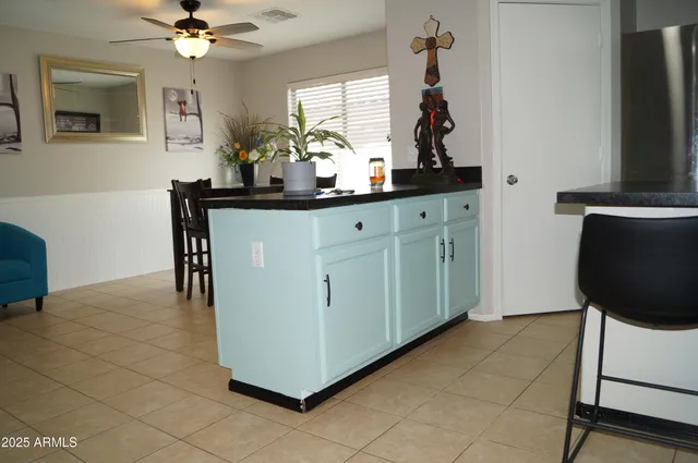 a kitchen with a stove a refrigerator and a white cabinets