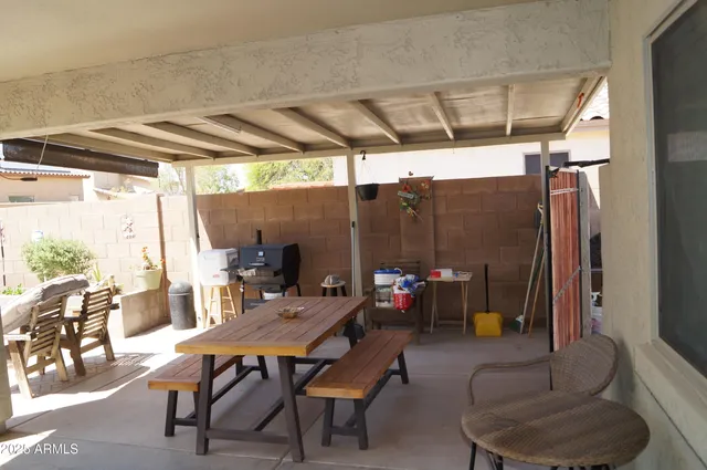 a swimming pool with some potted plants and large tree