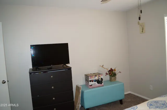 a living room with furniture and a dining table with wooden floor