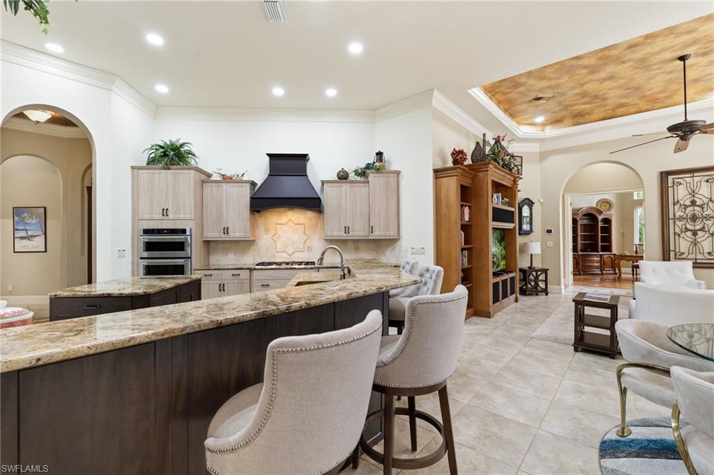 20421 Chapel Trace Estero, FL 33928 - Photo 12 of 50 a large kitchen with a table and chairs