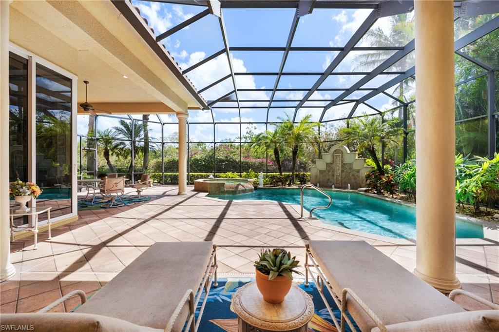 20421 Chapel Trace Estero, FL 33928 - Photo 17 of 50 a view of a patio with a dining table and chairs under an umbrella