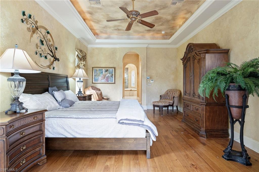 20421 Chapel Trace Estero, FL 33928 - Photo 21 of 50 a bedroom with a bed and wooden floor