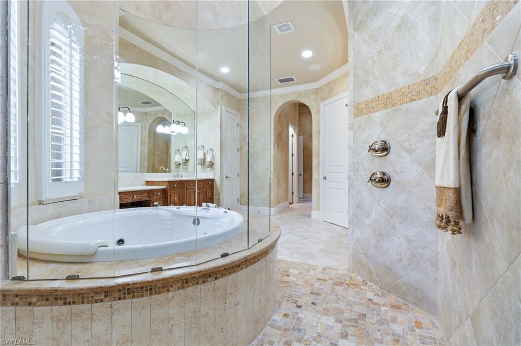 20421 Chapel Trace Estero, FL 33928 - Photo 22 of 50 a bathroom with a bathtub and a shower