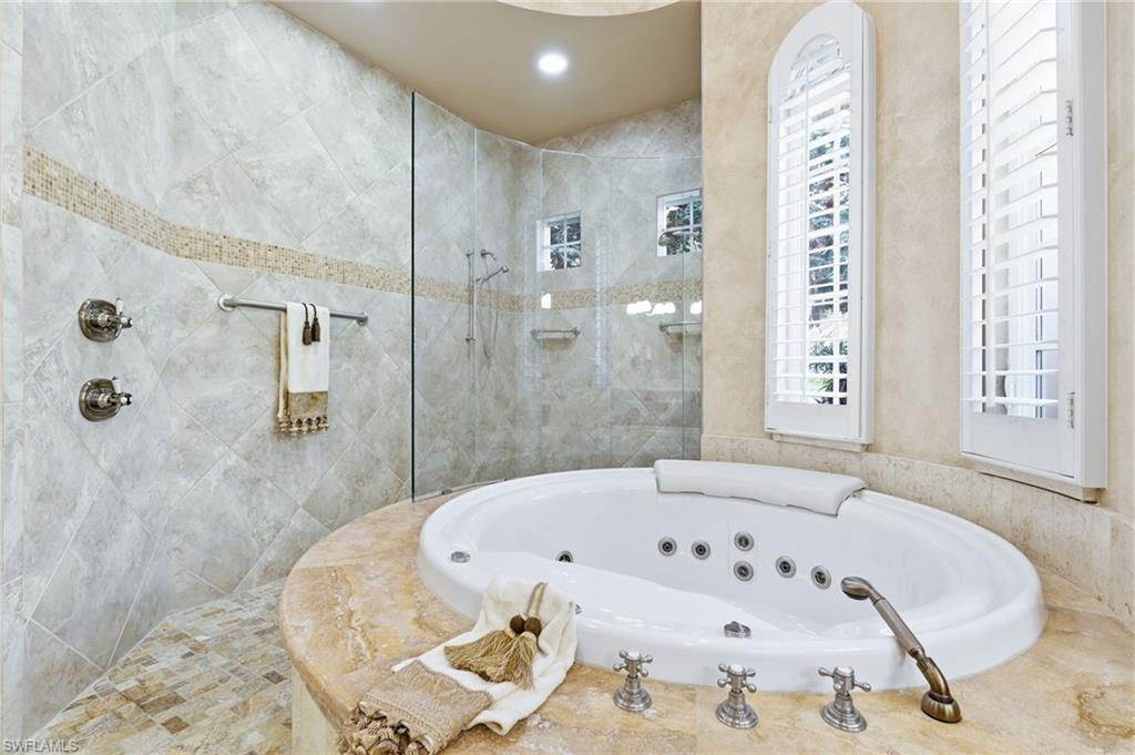 20421 Chapel Trace Estero, FL 33928 - Photo 23 of 50 a bathroom with bathtub and shower