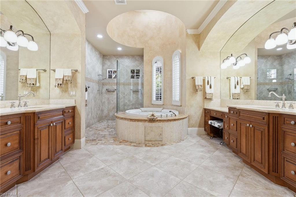 20421 Chapel Trace Estero, FL 33928 - Photo 24 of 50 a large bathroom with a double vanity sink a large mirror and a shower