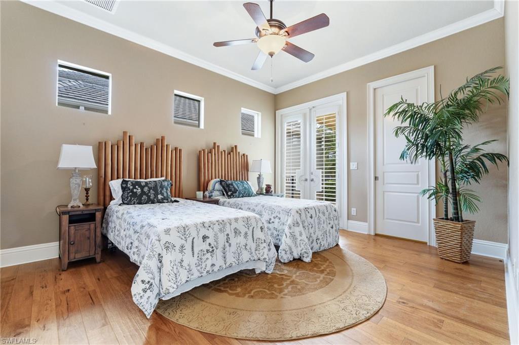 20421 Chapel Trace Estero, FL 33928 - Photo 25 of 50 a bedroom with a bed and wooden floor