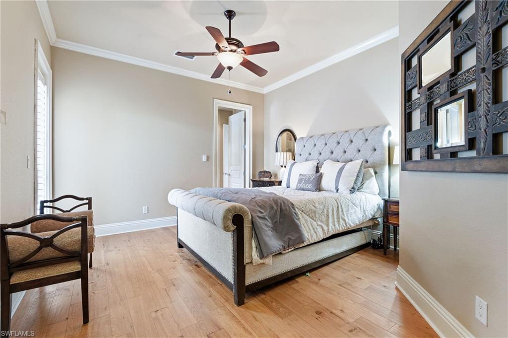 20421 Chapel Trace Estero, FL 33928 - Photo 27 of 50 a bedroom with a bed and a ceiling fan
