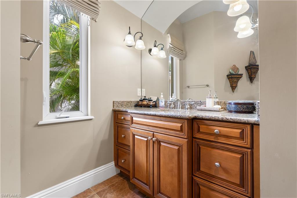 20421 Chapel Trace Estero, FL 33928 - Photo 29 of 50 a bathroom with a granite countertop sink a large mirror and a window