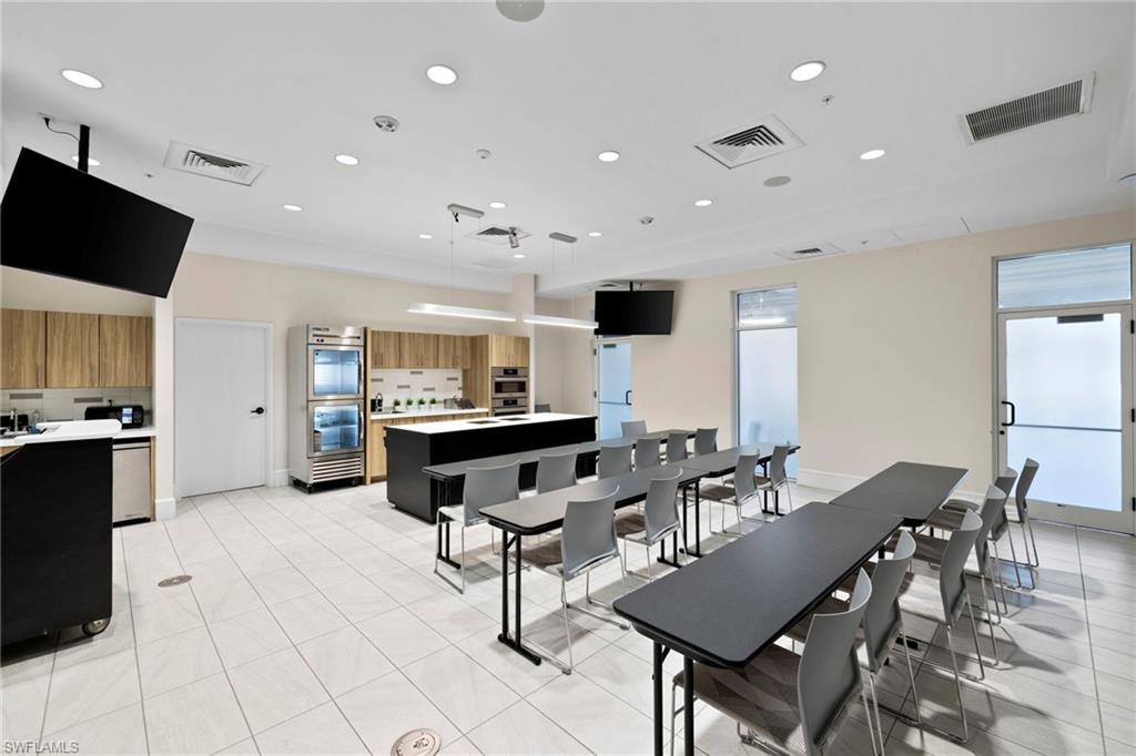 20421 Chapel Trace Estero, FL 33928 - Photo 38 of 50 a living room with furniture a flat screen tv and kitchen view