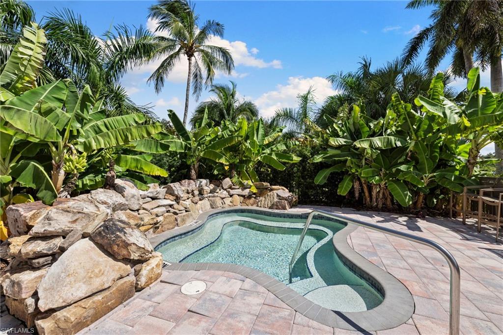 20421 Chapel Trace Estero, FL 33928 - Photo 41 of 50 a view of a swimming pool with a garden