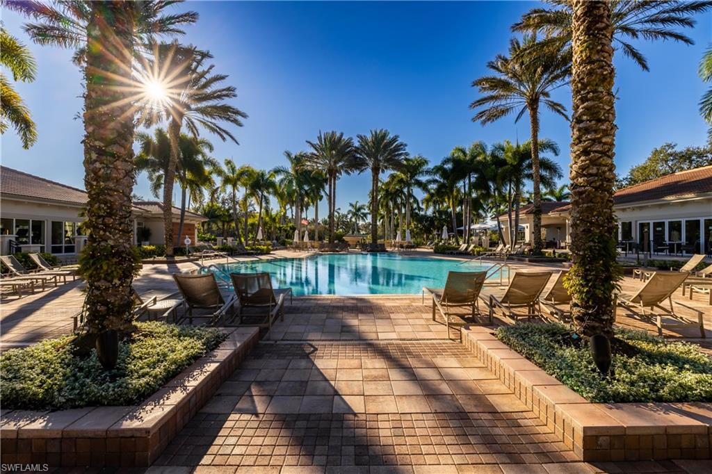 20421 Chapel Trace Estero, FL 33928 - Photo 46 of 50 a view of a swimming pool with lounge chair and palm trees
