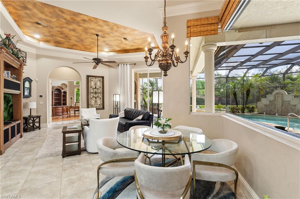 20421 Chapel Trace Estero, FL 33928 - Photo 9 of 50 a view of a dining room with furniture wooden floor and chandelier