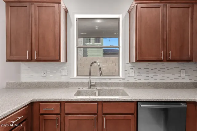a kitchen with granite countertop a sink and cabinets